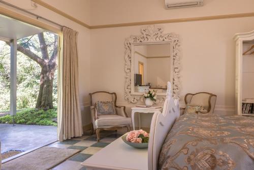 a bedroom with a bed and a mirror at River cottage in Tilba Tilba