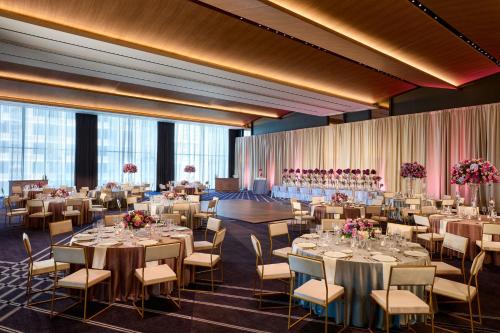 a ballroom with tables and chairs and a room with windows at JW Marriott Dallas Arts District in Dallas
