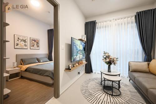 a bedroom with a bed and a couch and a mirror at Căn Hộ Westgate D11- 2N House in Ho Chi Minh City