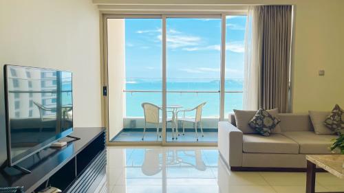 a living room with a couch and a table at The Sea Luxury Nha Trang Apartment in Nha Trang