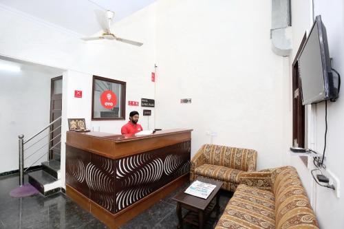 a man standing at a bar in a room at Hotel Kamal Palace in Chandīgarh