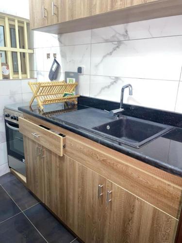 a kitchen with a sink and a stove at RESIDENCE MH SERVICES Cotonou in Cotonou