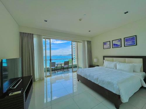 a bedroom with a bed and a view of the ocean at The Sea Luxury Nha Trang Apartment in Nha Trang