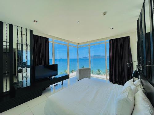 a bedroom with a large bed with a view of the ocean at The Sea Luxury Nha Trang Apartment in Nha Trang