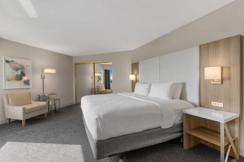 a hotel room with a bed and a chair at Crowne Plaza Houston Med Ctr-Galleria Area by IHG in Houston