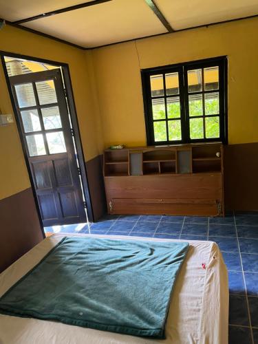 Than Sadet Beach的住宿－Silver cliff room 15，一间卧室设有一张床和两个窗户。
