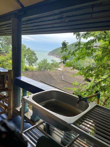 a sink on a balcony with a view of the ocean at Silver cliff room 15 in Than Sadet Beach