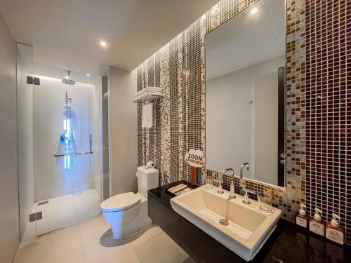 a bathroom with a sink and a toilet and a mirror at The Sea Luxury Nha Trang Apartment in Nha Trang