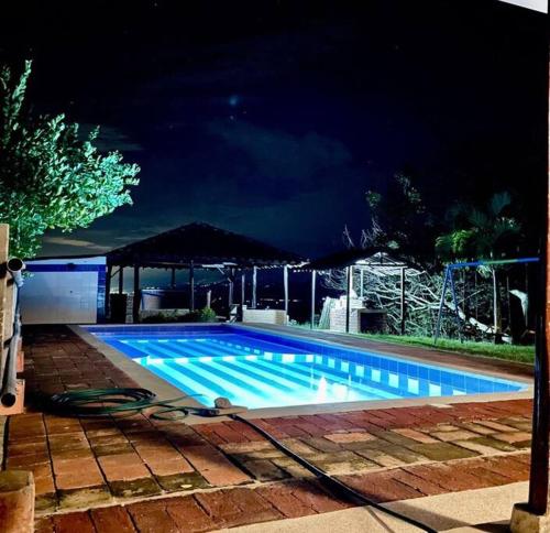 a large swimming pool at night with at EL PAILON FINCA in Quebradaseca