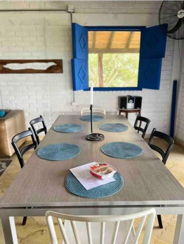 a table with four chairs and a lamp on it at EL PAILON FINCA in Quebradaseca