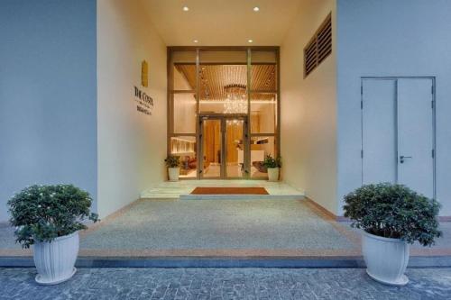 a lobby of a building with two potted plants at The Sea Luxury Nha Trang Apartment in Nha Trang
