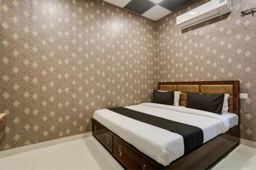 1 dormitorio con 1 cama grande en una habitación en OYO Hotel Kingland Water Park Rohtak, en Rohtak
