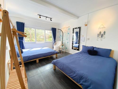 a bedroom with two bunk beds and a ladder at Belle House Đà Lạt in Da Lat