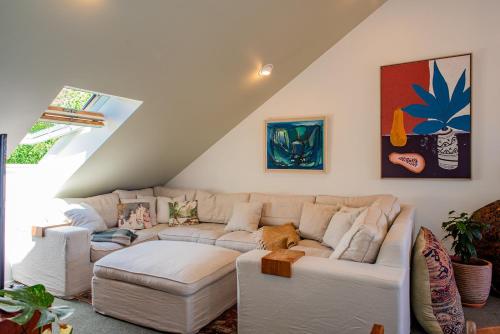 a living room with a couch and a table at Bali Escape, tropical gardens, close to 3 beaches! in Bowentown