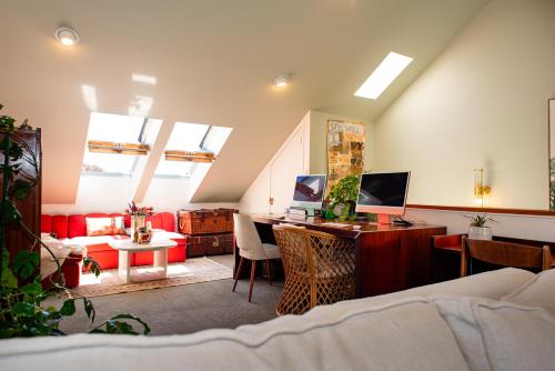 a living room with a desk with a computer on it at Bali Escape, tropical gardens, close to 3 beaches! in Bowentown