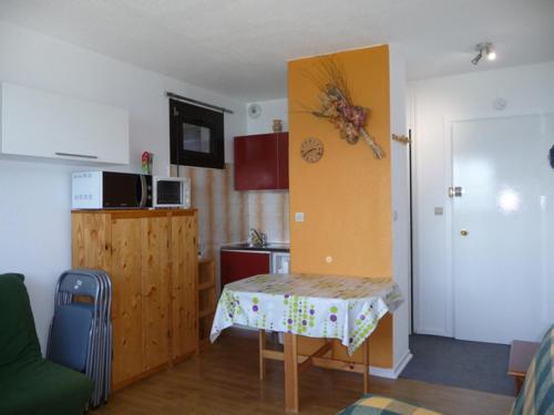 a small kitchen with a table in a room at Studio Les Adrets-Prapoutel, 1 pièce, 3 personnes - FR-1-771-6 in Les Adrets