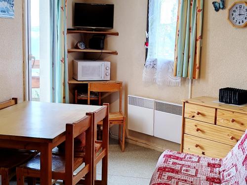 a living room with a table and a microwave at Appartement Les Adrets-Prapoutel, 2 pièces, 5 personnes - FR-1-771-32 in Les Adrets