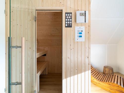 a wooden sauna with a bench in a room at Nice holiday home in Scherpenisse with terrace 