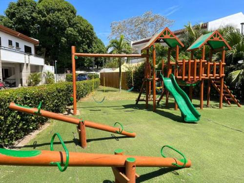 a park with a playground with a slide at Full condo in Tamarindo, CR in Tamarindo