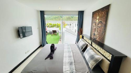 a child sitting on a bed in a room at Crystal Bay Tropical Residence in Koh Samui 