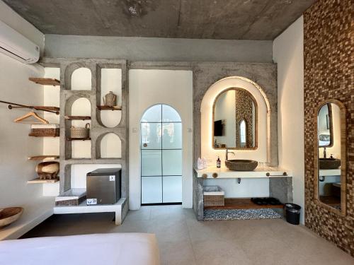 a bathroom with a sink and a mirror at El Tropico Boutique Hotel in Kuta Lombok