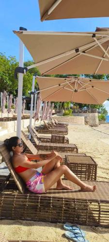 a woman laying in a chair on the beach at Mactan Newtown Beach Condo in Mactan