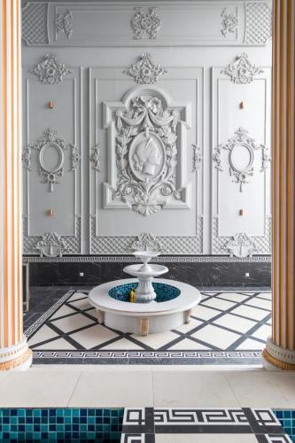 a white room with a fountain in the middle of a floor at Arte Cheras at Kuala Lumpur in Kuala Lumpur