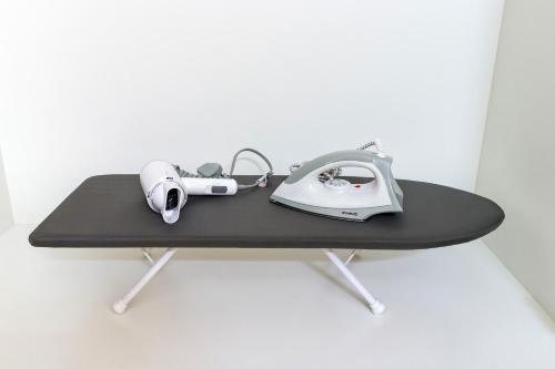 a table with a telephone and headphones on it at Arte Cheras at Kuala Lumpur in Kuala Lumpur