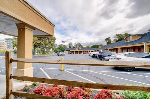 a building with cars parked in a parking lot at Budget Inn Falls Church in Falls Church