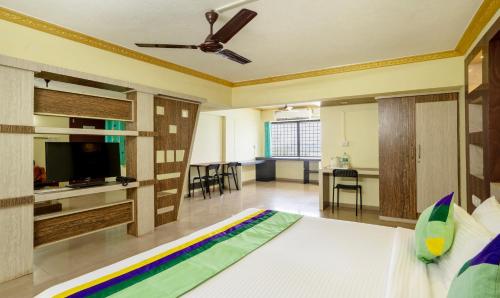 Una televisión o centro de entretenimiento en Itsy Hotels Vijaya Residency