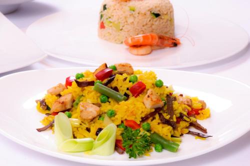 a plate of food with rice and shrimp and vegetables at Ko Lanta Amantra Lake View Resort in Ko Lanta