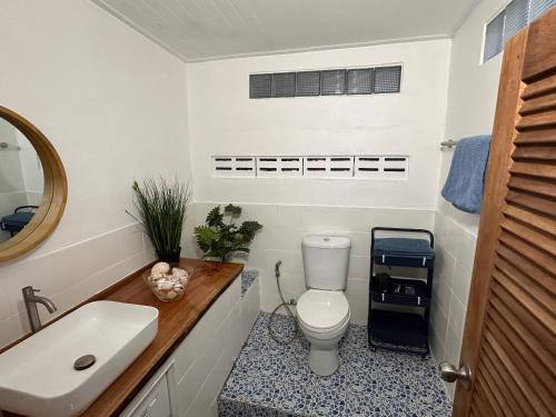 a bathroom with a white toilet and a sink at Coral Cottage Beach House @ Phang Nga in Thai Muang