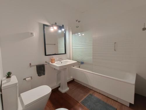 a bathroom with a sink and a toilet and a tub at Rooms in Heart of Gothic in Barcelona