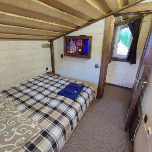 a bedroom with a bed in a room with a window at Family Plai in Yaremche