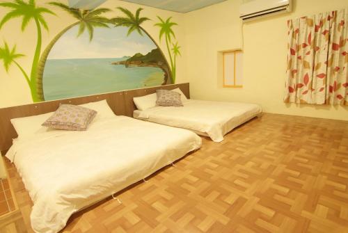 En eller flere senge i et værelse på Shi-Jia B&B