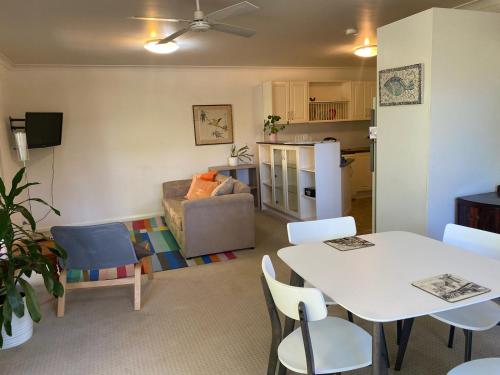 a living room with a table and chairs and a kitchen at Very Comfortable Granny Flat in Yass