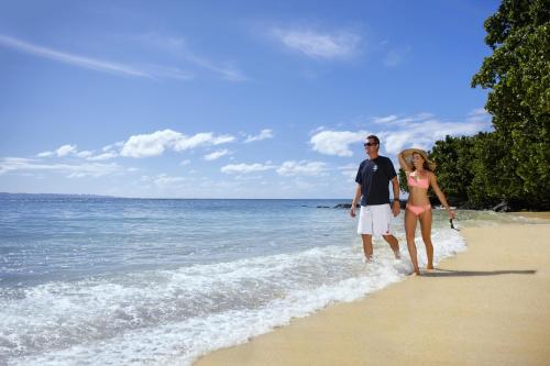 a man and a woman walking on the beach at Taveuni Island Resort & Spa in Matei