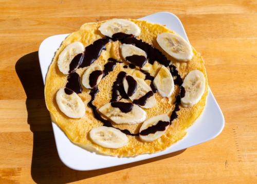a dessert with chocolate and banana slices on a plate at Green Homestay in Cat Ba