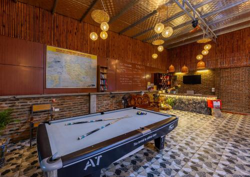 a pool table in a room with a map at Green Homestay in Cat Ba