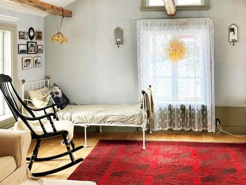 a living room with a bed and a window at Holiday home SILJANSNÄS in Siljansnäs