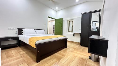 A bed or beds in a room at Better Inn AC Villa Kovalam
