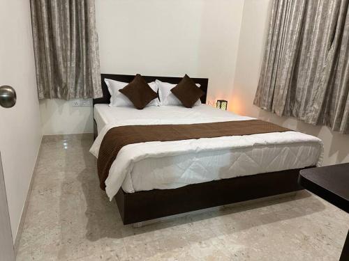 a bedroom with a large bed in a room at Passaddhi Serviced Apartment T2 in Mysore
