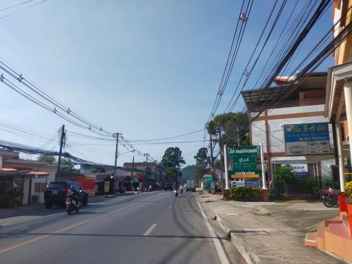 an empty street with motorcycles on the road at Goh Residence in Chaweng