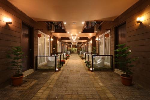a hallway of a building with urinals and potted plants at Sinon Baga Retreat in Baga