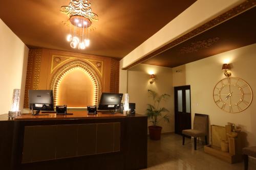 an office with a reception desk with a clock on the wall at Sinon Baga Retreat in Baga