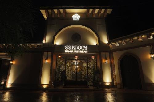 a building with a sign on the front of it at night at Sinon Baga Retreat in Baga