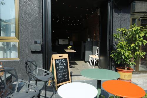 a restaurant with tables and chairs and a chalkboard at Beijing MutianyuGreat Wall Let'sgo Hotel&Bar in Huairou