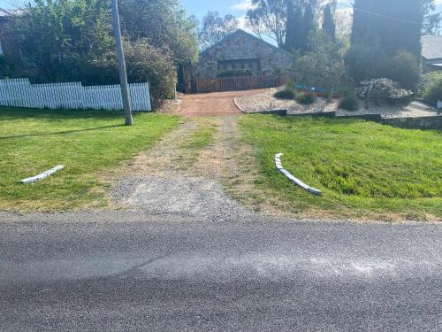 an empty road in a yard with a fence at Private Room with Ensuite in Yass