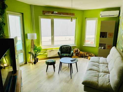 a living room with a couch and a dog laying on the floor at Sunrise Smart Home in Varna City