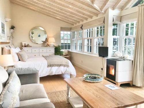 a bedroom with a bed and a fireplace at Coastal Chic waterfront studio in Kinsale